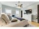 Bright main bedroom featuring a ceiling fan, large windows, and neutral wall colors for a serene and relaxing space at 5821 Clarion St # J8, Cumming, GA 30040