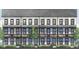 Elegant townhome featuring a brick facade, dark trim, multiple windows, and charming balconies at 6505 Cortland Walk, Alpharetta, GA 30005