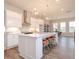 Bright kitchen features white cabinets, stainless steel appliances, a center island and pendant lighting at 6505 Cortland Walk, Alpharetta, GA 30005