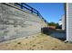 Backyard with stone retaining wall and wood fence at 67 Highgrove Way, Dallas, GA 30157