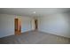 Bedroom features neutral carpet and walls, with a doorway to another room at 67 Highgrove Way, Dallas, GA 30157