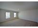 Light-filled bedroom with two windows and neutral carpeting at 67 Highgrove Way, Dallas, GA 30157