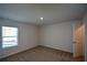 Bright bedroom with a large window, neutral carpet, and fresh, white walls at 67 Highgrove Way, Dallas, GA 30157