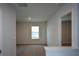 Neutral bedroom with plush carpet, window, and doorway leading to additional spaces at 67 Highgrove Way, Dallas, GA 30157