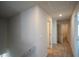 A white hallway that connects to another bedroom, and the stairway at 67 Highgrove Way, Dallas, GA 30157