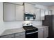 Kitchen featuring stainless steel appliances, grey cabinets with granite countertops and white subway tile backsplash at 67 Highgrove Way, Dallas, GA 30157