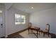 Bright room with a table and two chairs in front of a window with wood-look floors and light colored walls at 67 Highgrove Way, Dallas, GA 30157