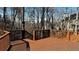Wooden back deck with railings offering views of the trees in the backyard at 2674 Misty Rock Cv, Dacula, GA 30019