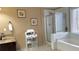 Bright bathroom with a combo tub and shower plus a granite vanity and plenty of storage at 2674 Misty Rock Cv, Dacula, GA 30019