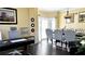 Combined open office/dining space with neutral walls, hardwood floors, and coordinated furniture at 2674 Misty Rock Cv, Dacula, GA 30019