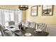 Formal dining room featuring a rectangular dark wood table, upholstered chairs, and a modern chandelier at 2674 Misty Rock Cv, Dacula, GA 30019