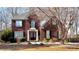 Charming two-story brick home featuring a well-manicured front yard and a classic architectural design at 2674 Misty Rock Cv, Dacula, GA 30019