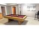 Spacious game room featuring a pool table, bar area, and neutral decor at 2674 Misty Rock Cv, Dacula, GA 30019
