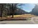 Scenic view of the Apalachee River Club golf course with mature trees and players on the fairway at 2674 Misty Rock Cv, Dacula, GA 30019