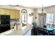 Charming kitchen with gray countertops, black appliances, and a breakfast bar for casual dining at 2674 Misty Rock Cv, Dacula, GA 30019
