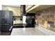 Close-up of a kitchen featuring granite countertops, stainless steel appliances, and tiled backsplash at 2674 Misty Rock Cv, Dacula, GA 30019