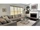 Cozy living room with a stone fireplace, built-in shelving, and a large sectional sofa at 2674 Misty Rock Cv, Dacula, GA 30019