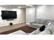 Inviting living room features a comfortable gray sofa and a large-screen television for entertainment at 2674 Misty Rock Cv, Dacula, GA 30019