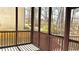 Cozy screened porch with natural light, offering a peaceful retreat with scenic views at 2674 Misty Rock Cv, Dacula, GA 30019