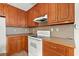 Well-lit kitchen with classic wood cabinets, an electric range, and efficient countertop space at 306 Birch St, Canton, GA 30114