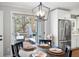 Well-lit dining area open to the kitchen, featuring stainless steel appliances and access to an outdoor deck at 3890 Cherrydale Se Ln, Smyrna, GA 30082