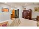 Bright bedroom features a wooden dresser, artwork, and a bathroom entrance at 1261 Lavista Ne Rd # E9, Atlanta, GA 30324