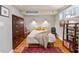 Bedroom featuring a red patterned rug, hardwood floors, and modern decor at 1261 Lavista Ne Rd # E9, Atlanta, GA 30324
