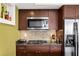 Well-equipped kitchen with stainless steel appliances, tile backsplash, and rich wood cabinetry at 1261 Lavista Ne Rd # E9, Atlanta, GA 30324