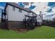 A large home featuring a deck, steps leading to the backyard, and a stone patio at 2077 Towne Mill Ave, Canton, GA 30114