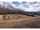 Outdoor baseball field with lighting surrounded by a fence under a partly cloudy blue sky at 2077 Towne Mill Ave, Canton, GA 30114