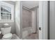 Neutral bathroom with a shower/tub combo and a bright window at 2077 Towne Mill Ave, Canton, GA 30114