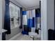 Well-lit bathroom with a stylish blue shower curtain and matching window treatments at 2077 Towne Mill Ave, Canton, GA 30114