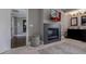 Cozy bathroom includes gray cabinetry, fireplace, television, and modern tile flooring at 2077 Towne Mill Ave, Canton, GA 30114