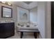 Well-lit bathroom featuring a soaking tub, dark cabinetry, and modern fixtures at 2077 Towne Mill Ave, Canton, GA 30114