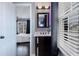 Charming bathroom featuring a dark wood vanity, modern lighting, and a glimpse into the bedroom at 2077 Towne Mill Ave, Canton, GA 30114