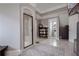 Elegant bathroom with a glass-enclosed shower, storage shelving, and neutral tiling at 2077 Towne Mill Ave, Canton, GA 30114