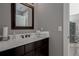 Bathroom vanity featuring a white countertop, dark wood cabinets, and a framed mirror at 2077 Towne Mill Ave, Canton, GA 30114