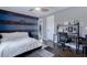 Comfortable bedroom featuring a unique blue accent wall with rustic wood trim and hardwood floors at 2077 Towne Mill Ave, Canton, GA 30114