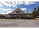 Beautiful clubhouse exterior featuring landscaping and a covered entryway at 2077 Towne Mill Ave, Canton, GA 30114