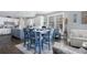 Bright dining area boasts a blue table set, hardwood floors, and modern decor at 2077 Towne Mill Ave, Canton, GA 30114