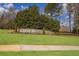 Stone sign welcomes you to Towne Mill, surrounded by lush landscaping and mature trees at 2077 Towne Mill Ave, Canton, GA 30114