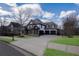 Beautiful two-story home with a three-car garage, stone accents, and well-maintained landscaping at 2077 Towne Mill Ave, Canton, GA 30114