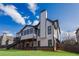 This home's exterior features a large deck, a stone foundation, and many windows at 2077 Towne Mill Ave, Canton, GA 30114