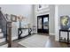 Welcoming foyer with dark hardwood floors, a decorative rug, and an elegant staircase at 2077 Towne Mill Ave, Canton, GA 30114