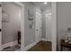 Hallway with hardwood floors, neutral walls with trim and artwork; and a view into the next room at 2077 Towne Mill Ave, Canton, GA 30114