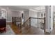 Upstairs landing with wood railing, hardwood floors, neutral walls and access to multiple rooms at 2077 Towne Mill Ave, Canton, GA 30114