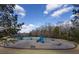 Outdoor playground with swings and slides and benches under a partly cloudy blue sky at 2077 Towne Mill Ave, Canton, GA 30114