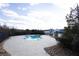 Outdoor swimming pool with surrounding patio, landscaping, and slide under a sunny blue sky and scattered clouds at 2077 Towne Mill Ave, Canton, GA 30114