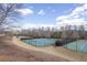 Outdoor tennis courts surrounded by a fence under a partly cloudy blue sky at 2077 Towne Mill Ave, Canton, GA 30114