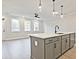 Bright kitchen with an island with bar seating, sleek gray cabinets, and a modern faucet at 4651 Larkfield Way, Powder Springs, GA 30127